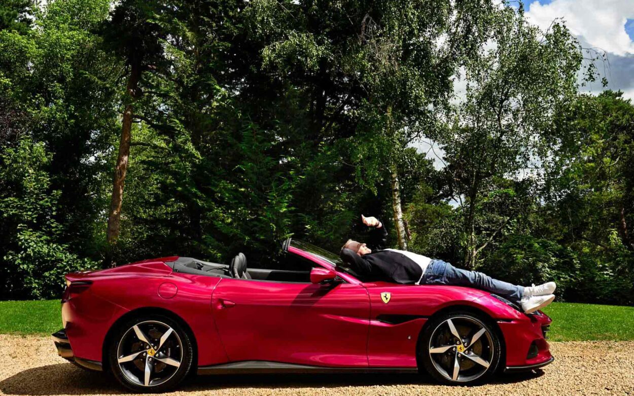 Actor Christopher Lambert photographed by Gianluigi Di Napoli lying on a Ferrari Portofino for Ferrari Official Magazine